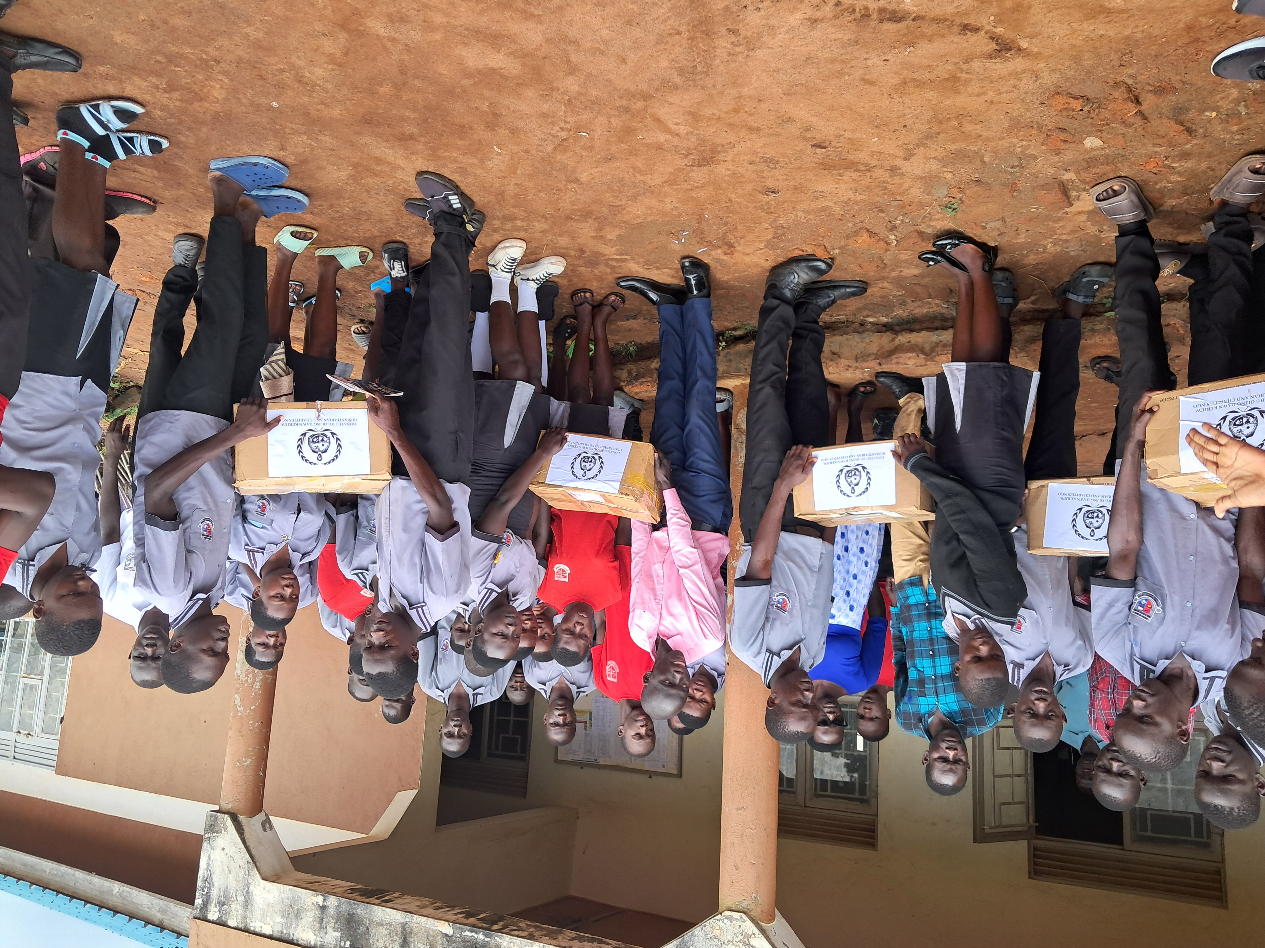 Distributing scholastic materials at an underserved and underpriviledged Secondary School, Myene village, Kamdini Sub-county, Oyam District - July 2025.